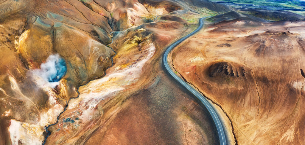 Aerial panoramic view on road in Iceland. Aerial landscape above highway in the geysers valley. Icelandic landscape from air. Famous place. Travel - image