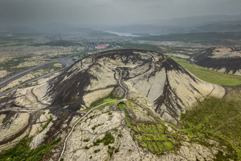 drone point of view of the Grabrok volcanic crater in northwestern Icleand