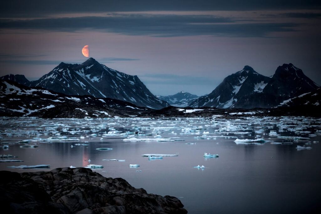 A moonrise over Ammassalik Fjord in East Greenland
