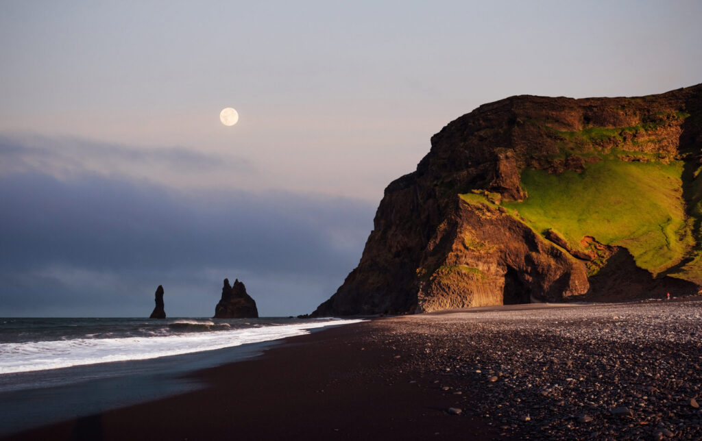 Famous Reynisdrangar rock formations at black Reynisfjara Beach. Coast of the Atlantic ocean near Vik, southern Iceland