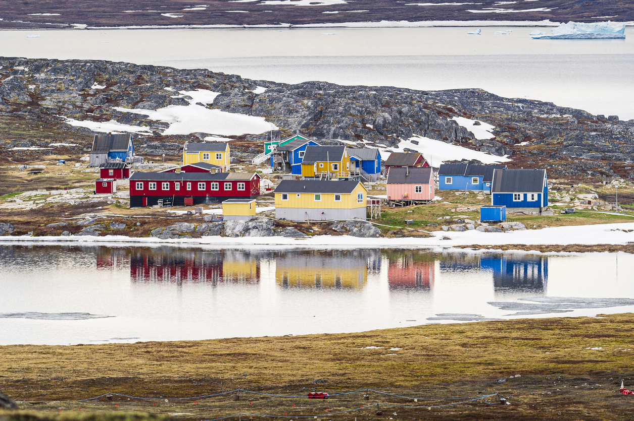 Aerial shot of colorful houses at Ilimanaq on the Disko Bay background